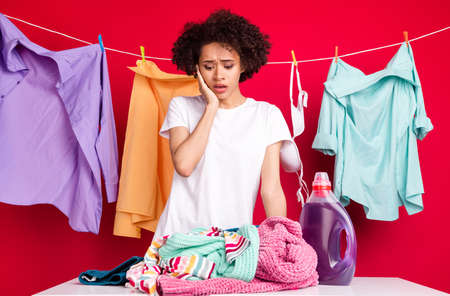 Photo portrait woman amazed need to wash clothes isolated vivid red color backgroundの写真素材