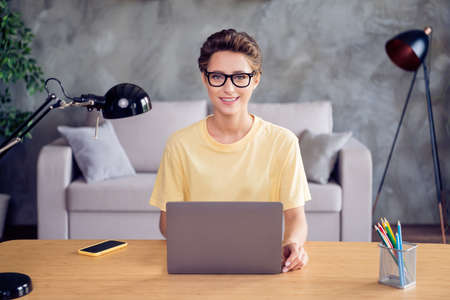 Portrait of attractive cheerful skilled girl copywriter using laptop it project start-up at home loft industrial interior indoorsの写真素材