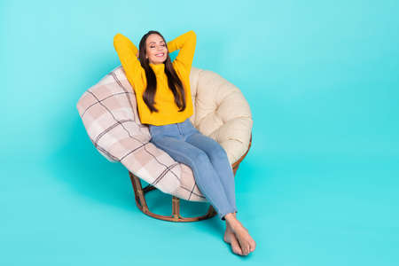 Full size photo of adorable peaceful lady hands behind head closed eyes drowse isolated on turquoise color backgroundの写真素材