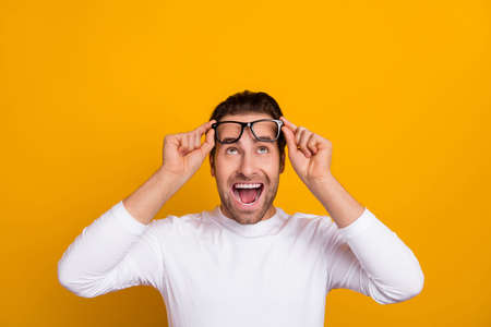 Photo of hooray brunet guy try eyewear look empty space wear white shirt isolated on bright yellow...