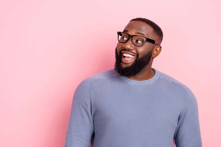 Photo of curious dreamy guy look empty space wear spectacles grey shirt isolated pink color...