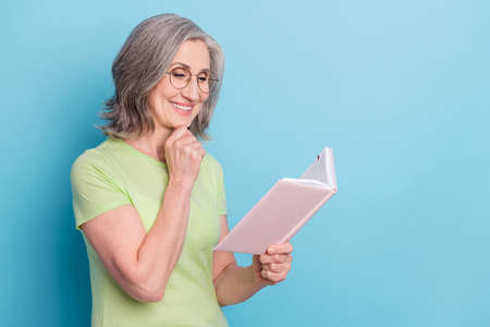 Photo of charming old smart woman look book think wear glasses smile isolated on pastel blue color...