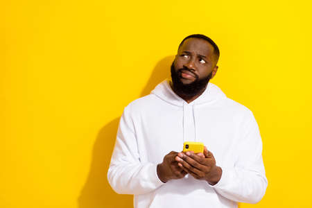 Photo of sad millennial beard man hold telephone look promo wear white sportscloth isolated on...