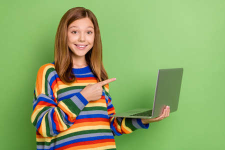Portrait of attractive cheerful funny girl using laptop demonstrating learn study education isolated...