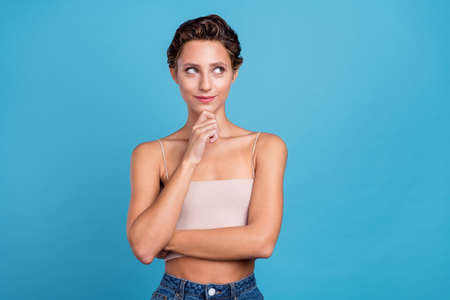 Portrait of attractive curious cheery girl overthinking copy blank space isolated over bright blue color backgroundの写真素材