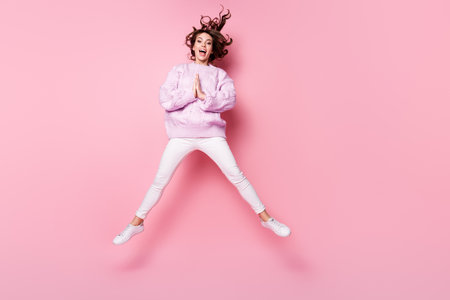Full length body size view of nice cheerful wavy-haired girl jumping having fun asking favor gift...