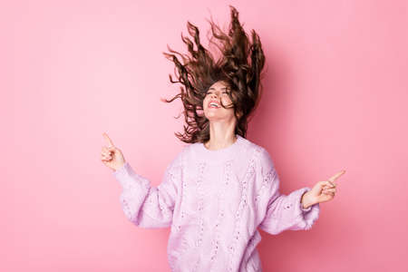 Portrait of lovely cool cheerful dreamy girl dancing having fun enjoying isolated over pink pastel...