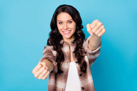 Photo of young happy cheerful smiling positive girl hold invisible steering wheel isolated on blue color backgroundの写真素材