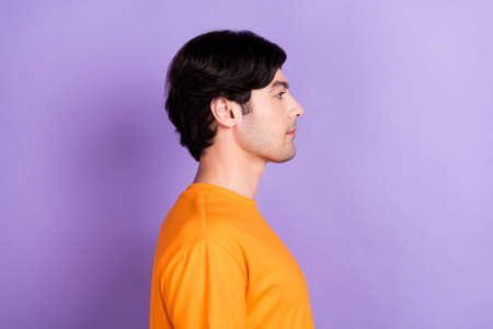 Profile side photo of young serious calm charming man look empty space isolated on purple color...