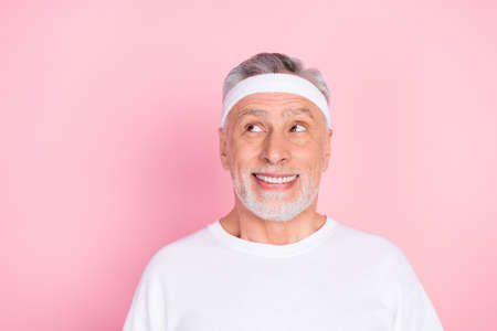 Photo portrait of elder man in headband smiling looking copyspace in white t-shirt isolated on...