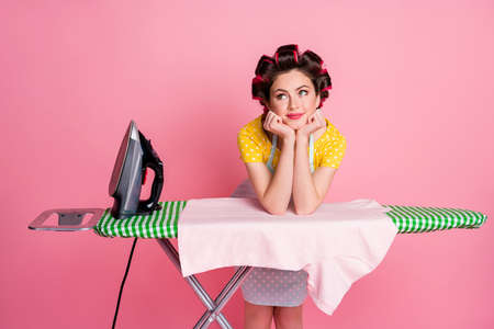 Portrait of dreamy girl look copyspace iron board t-shirt wear dotted dress isolated on pastel color backgroundの写真素材