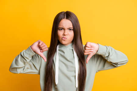 Photo of cute serious school girl wear casual grey outfit showing two hands arms dislikes isolated...