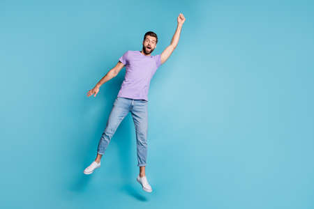 Full length body size photo of jumping man pretending superhero flying amazed in casual clothes...