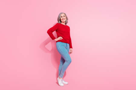 Full length body size view of attractive cheerful grey-haired middle-aged woman posing isolated over...