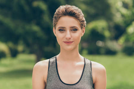 Photo of positive energetic cute sportswoman lady look camera wear grey top nature park garden...