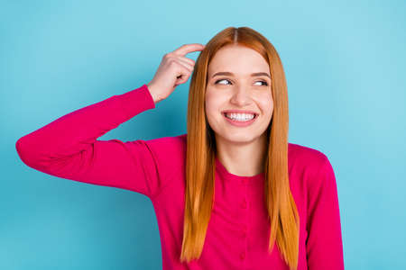 Portrait of attractive cheerful red-haired girl thinking looking aside oops clue isolated over vivid...