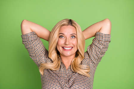Portrait of attractive dreamy cheerful woman resting wearing checked shirt isolated over bright green color backgroundの写真素材