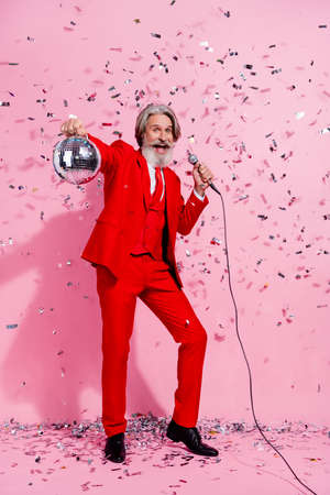 Vertical full length body size view of funky cheerful trendy grey-haired man mc singing clubbing isolated over pink pastel color backgroundの写真素材