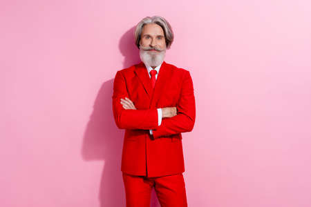 Photo of attractive charismatic man pensioner dressed red jacket arms crossed isolated pink color...