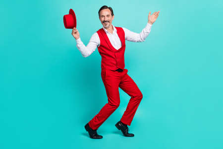 Full body photo of aged man good mood well-dressed enjoy event isolated over turquoise color backgroundの写真素材