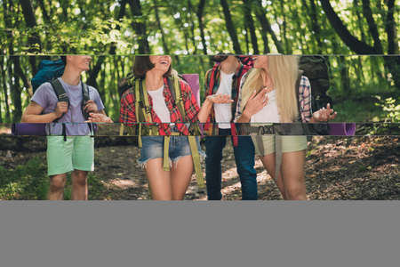 Portrait of attractive cheerful group of four people going talking exploring wild wood having fun...
