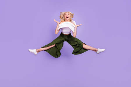 Full length body size photo girl jumping high careless in stylish outfit isolated pastel purple...