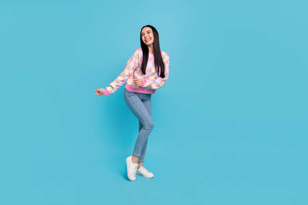 Photo of pretty funky lady dressed print pullover dancing empty space isolated blue color background
