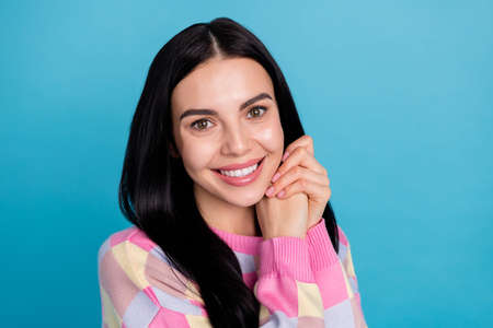 Photo of shiny adorable young woman wear pink sweater arms together cheek isolated blue color...