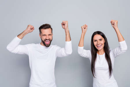 Photo of celebrate young couple yell wear white shirt isolated on grey backgroundの写真素材
