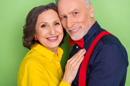 Cropped close up photo of two charming positive soulmates hug look camera isolated on green color...