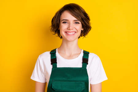 Photo of pretty positive girl toothy smile have good mood look camera isolated on yellow color...
