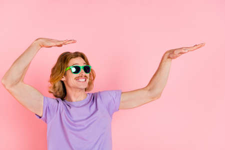 Portrait of attractive cheerful carefree guy dancing fooling having fun isolated on pink pastel color backgroundの写真素材
