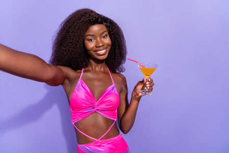 Photo of pretty positive afro girl wear pint sexy outfit tacking selfie drinking beverage smiling...