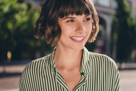 Photo portrait female student in striped shirt smiling walking on sunny city streets in summer...