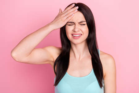 Photo of young girl hand touch head pain suffer injury headache spasm isolated over pastel color backgroundの写真素材