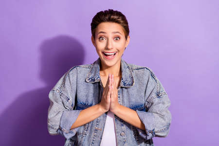 Photo of young amazed shocked woman clap hands anticipation good mood isolated on purple color backgroundの写真素材