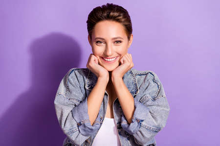 Photo of young cheerful happy positive woman hold hands face smile enjoy isolated on purple color...
