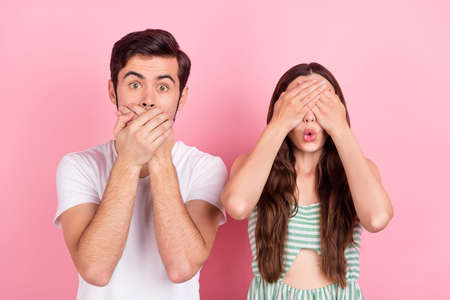 Photo of impressed millennial brown hair couple close face wear white t-shirt dress isolated on pink color backgoundの写真素材