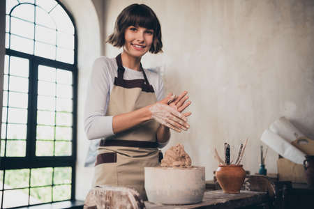 Photo of self employed lady potter have internet seminar teaching doing designing pot in workroom