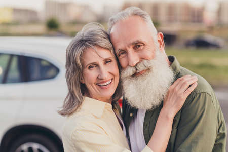 Photo of mature married couple cuddle romantic date urban rent car automobile ride travel weekend...