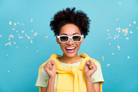 Photo of youth lovely african girl celebrate success achievement fists hands triumph isolated over blue color backgroundの写真素材