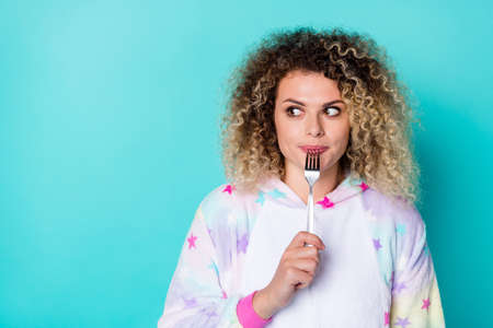 Photo of nice young wavy hairdo lady eat look promo wear pajama isolated on blue backgroundの写真素材