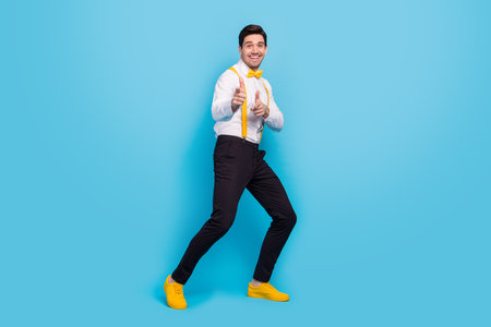 Full size portrait of funny excited person point fingers camera you isolated on blue color backgroundの写真素材