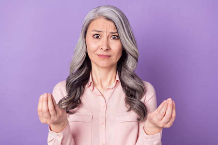 Portrait of attractive angry worried evil fury woman saying pretense isolated over violet purple...