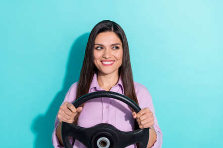 Photo of brunette funky mature lady drive auto look promo wear purple shirt isolated on teal color backgroundの写真素材