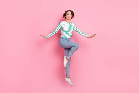 Full length body size view of attractive cheerful girl jumping having fun good mood isolated over...