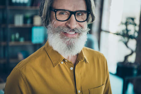 Cropped view portrait of attractive cheerful gray-haired man employer partner career promotion at work place station indoorsの写真素材