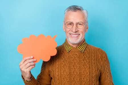 Photo of positive man promoter tell paper speech cloud information isolated blue color backgroundの写真素材