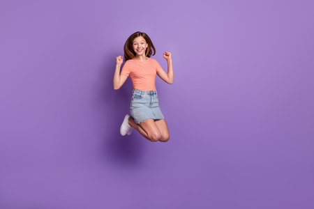 Full length body size view of attractive cheerful lucky girl jumping rejoicing having fun isolated...