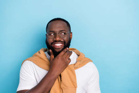 Portrait of young businessman handsome guy dreaming visualize success brainstorming isolated on blue color backgroundの写真素材